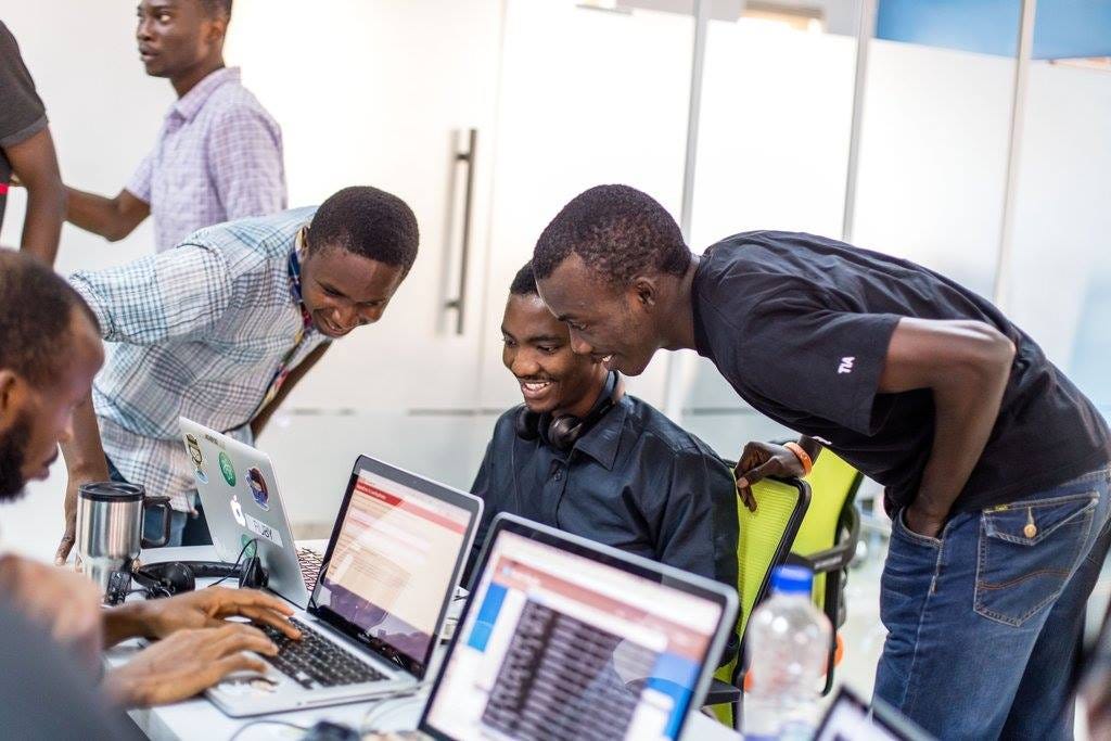 Africa professional tech team collaborating in modern office environment